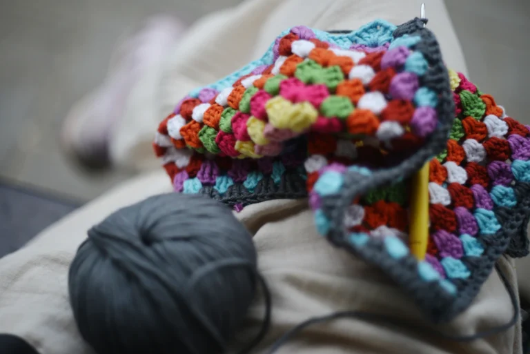 Crochet stitch sampler in progress with yarn